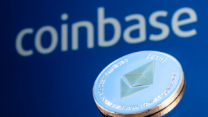 Coinbase (COIN), is an American company that operates a cryptocurrency exchange platform.  Ethereum coin (ETH-USD) on the background of the inscription Coinbase.