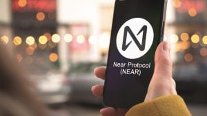NEAR Protocol (NEAR-USD) logo on a smartphone held by a person
