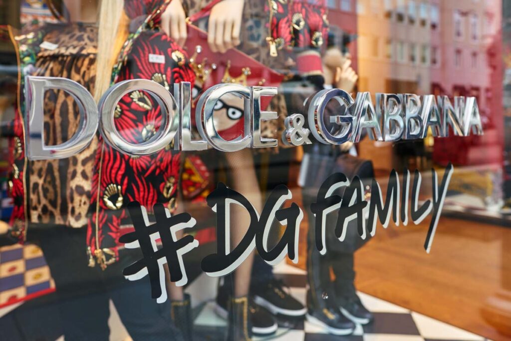 Close-up of Dolce & Gabbana signage in a store window, representing Dolce & Gabbana's collective action.