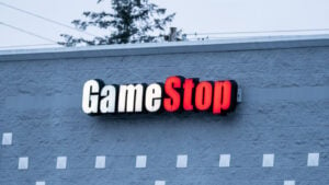 GameStop (GME) sign on side of building in early morning blue light