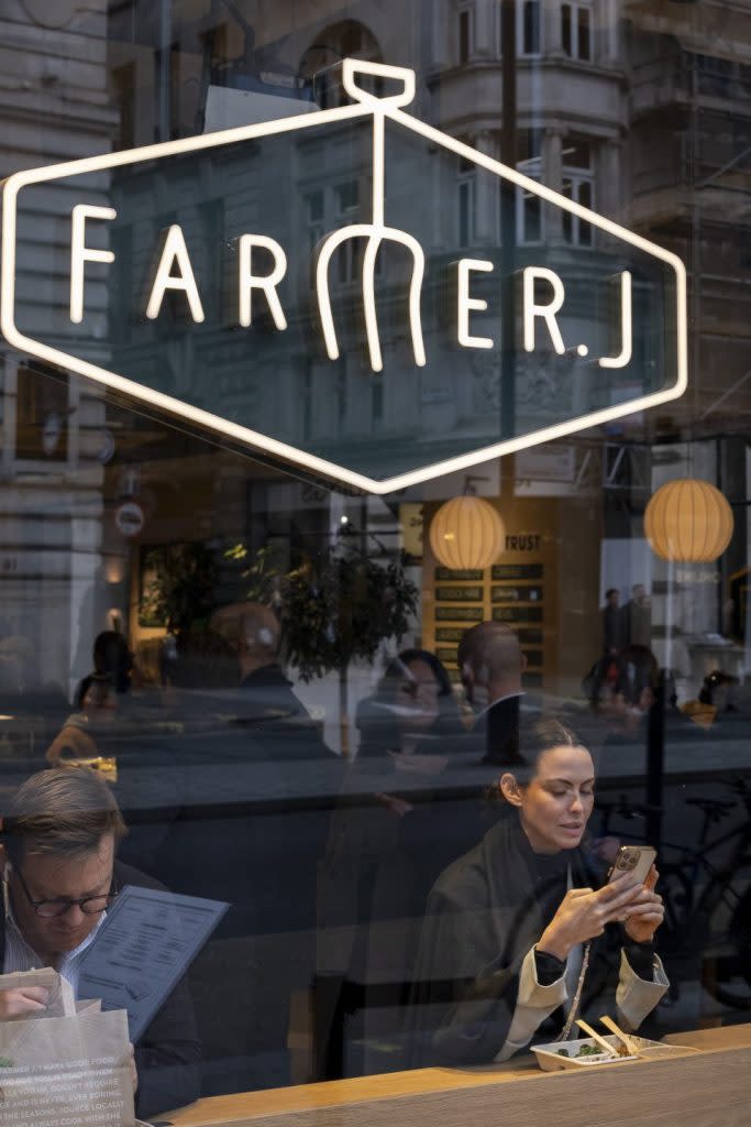 People eat lunch at a window seat at a branch of the Farmer J restaurant chain on February 5, 2024 in London, United Kingdom. (Photo by Mike Kemp/In Pictures via Getty Images)